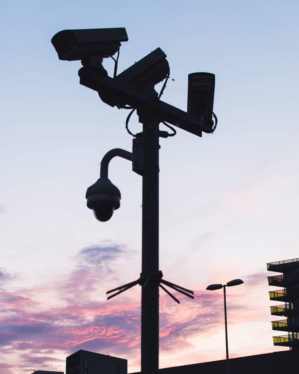 black lamp post with mounted cameras